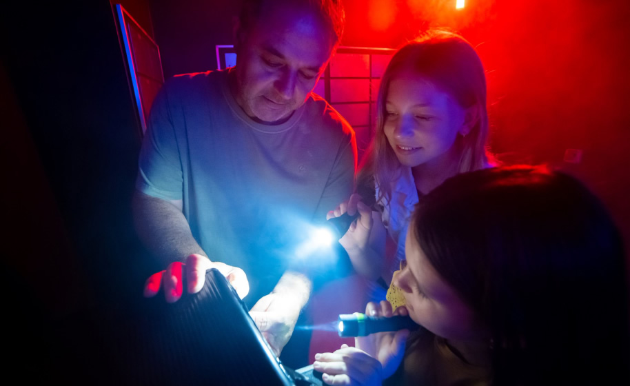 An adult and 2 children trying to open the final safe