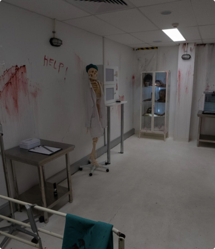 A hospital room with blood splattered on the walls.
