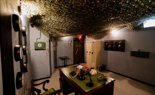 Empty Bunker escape room at Fox in a Box Adelaide with military-style décor, control panels, and dim atmospheric lighting.